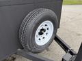 A white wheel mounted on a black frame with a textured tire and a visible rim featuring five lug nut openings