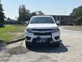 A white 2017 Chevrolet Colorado with a tow hitch is positioned directly in front, showcasing its front grille and headlights