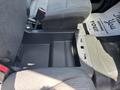 An interior view of a 2021 Ford F-150 showing the space between the front seats with a storage compartment and controls