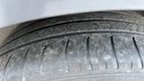 Close-up of a worn tire from a 2018 Hyundai Sonata showing visible tread wear and dirt on the surface
