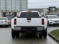 A white 2013 Chevrolet Silverado 3500HD pickup truck viewed from the rear with a visible Chevrolet bowtie logo on the tailgate