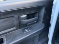 Close-up of the interior door handle and window switch of a 2021 RAM 5500 vehicle