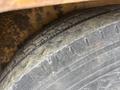 Close-up of a 2015 Vermeer Corporation BC1200XL tire showing tread patterns and wear details