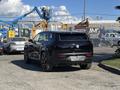A black 2023 Fisker Ocean SUV with a sleek design and modern features viewed from the rear