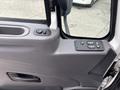 Interior view of a 2013 International DuraStar 4300 door panel featuring control buttons for windows and locks