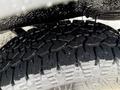 Close-up of a textured tire of a 2017 Mercedes-Benz Sprinter showing deep treads and water droplets on the surface