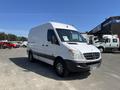 A white 2010 Mercedes-Benz Sprinter van with a high roof and front grille featuring the Mercedes-Benz emblem