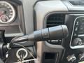 Close-up of the gear shift lever in a 2013 RAM 2500 featuring buttons for gear selection with plus and minus symbols
