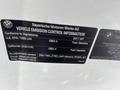 2011 BMW 3-Series vehicle emission control information label showing compliance details and specifications for gasoline fuel