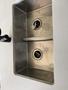 A stainless steel double kitchen sink with two drain openings and a smooth surface