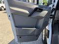 The interior door panel of a 2017 Mercedes-Benz Sprinter featuring a gray finish with a handle and storage compartment