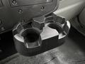 A black plastic cup holder with two compartments mounted in the interior of a 2020 International MV607 vehicle
