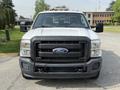 A white 2011 Ford F-350 SD with a black grille and front bumper features the Ford logo prominently displayed in the center