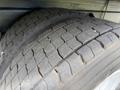 Close-up of two large, worn tires from a 2022 International MV607 showcasing tread pattern and rubber texture