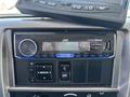 A JVC car stereo display showing AM radio with a time reading of 14:00 and various control buttons below it