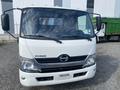 Front view of a white 2019 Hino 195 truck featuring a prominent Hino logo on the grille and two side mirrors