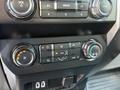 Control panel of a 2019 Ford F-550 featuring climate and audio controls with dials and buttons for air conditioning and ventilation settings