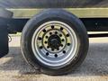 A close-up of a silver wheel from a 2022 Freightliner M2 106 featuring a black tire with the brand name Continental and the model Conti EcoPlus HS3