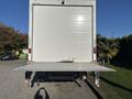 A 2022 Lion Lion6 truck with an open rear door and a lowered loading ramp positioned in the foreground