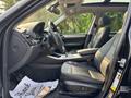 Interior view of a 2013 BMW X3 showing leather seats dashboard and gear shift with a thank you note on the floor mat