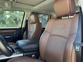 Interior of a 2015 RAM 1500 showing brown leather seats and a console between the front seats