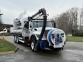 A 2013 International Workstar 7500 truck equipped with a large tank and vacuum hose for waste management applications
