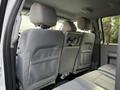 Interior view of a 2015 Ford F-550 showing the back seat with gray fabric upholstery and headrests
