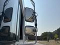 A 2018 Ford Econoline van showing side mirrors and partial view of the vehicle body