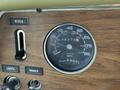 Dashboard of a 1976 GMC Motorhome featuring a speedometer with mph and km/h markings and other controls for wiper lights and washer