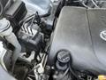 Close-up view of the engine compartment of a 2018 Toyota Highlander showing the engine block and various components such as cables and connectors