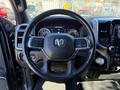 Steering wheel of a 2021 RAM 3500 with controls and dashboard instruments visible