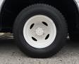 Close-up of a white wheel and tire from a 2018 Ford Econoline showcasing the wheel rim and tread details