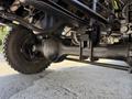 Close-up of the axle and tire of a 2009 International 3000 CE showing the robust axle design and the tread of the tire