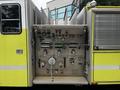 Front view of a 1995 Freightliner FL086 fire truck showing operational controls and gauges on the side panel in yellow and silver
