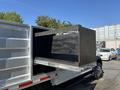 A 2019 Ford F-550 with a flatbed equipped with a wooden box that is partially pulled out from the truck's cargo area
