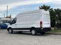 A 2020 Ford Transit 250 van with a white exterior and black trim parked at an angle showcasing its large cargo area and sliding side door
