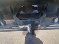 A heavy-duty truck hitch attachment for a 1997 Freightliner FL70 with a sturdy metal frame and two clevis pins for securing a trailer