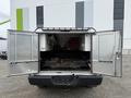 A 2016 RAM 1500 pickup truck with its tailgate down and rear doors open revealing a tool storage area inside