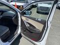 A 2018 Hyundai Santa Fe with the driver's side door open showcasing the interior features including the door panel and seat