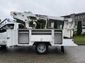 A 2012 Ford F-450 SD work truck with a Terex bucket lift mounted on the rear and an open utility bed displaying storage compartments