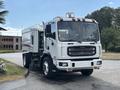 A white 2012 Autocar Xpert street sweeper with a large front grille and multiple lights on the roof is parked, showcasing its sweeping equipment and sturdy build
