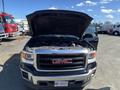 A 2014 GMC Sierra 1500 with the hood raised displaying the engine compartment