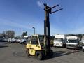 A yellow 1993 Hyster H80XL forklift with a raised mast and two forks visible in the foreground