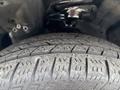 Close-up of a tread pattern on a tire from a 2014 Honda CR-V showcasing the grooves and texture of the rubber