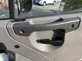 A close-up of the door handle and control mechanism on a 2013 Freightliner 114SD truck