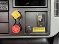 Dashboard controls of a 2006 International 4300 featuring air supply and trailer controls along with a safety warning sign