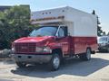 A red and white 2007 GMC C4500 TopKick box truck with a large cargo area and multiple front lights
