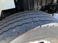 Close-up view of a tire on a 2010 International 4300 showing tread pattern and wear indicative of usage on a heavy-duty vehicle