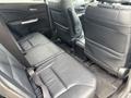 Interior view of a 2014 Honda CR-V showing the backseat with black leather upholstery and seatbelts