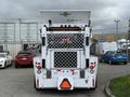 A 2012 Global M4 truck viewed from the rear with a distinctive diamond-patterned grille and a white body featuring a green Global logo on the top